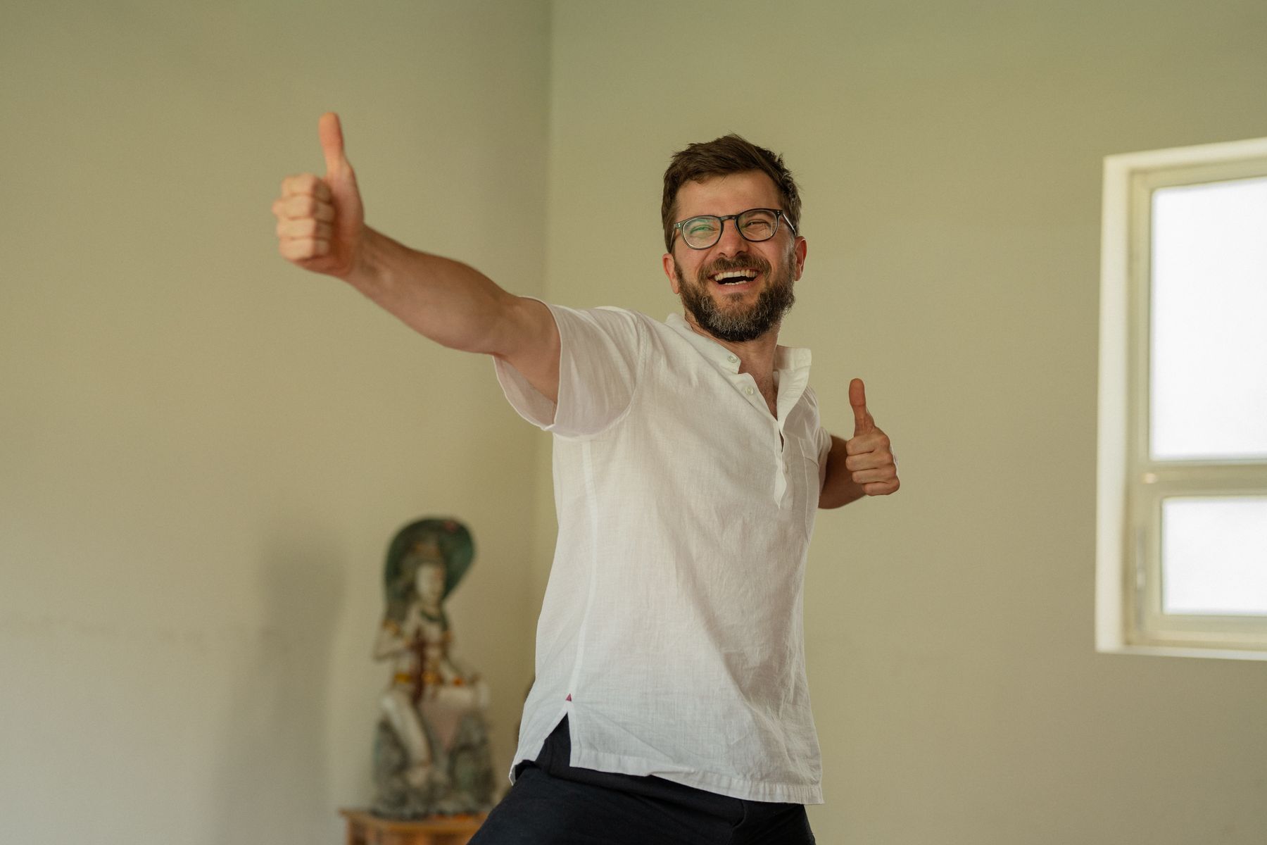Hannes Wartmann, Kundalini Kriya Yoga Lehrer in Winterthur, lacht und zeigt beide Daumen nach oben
